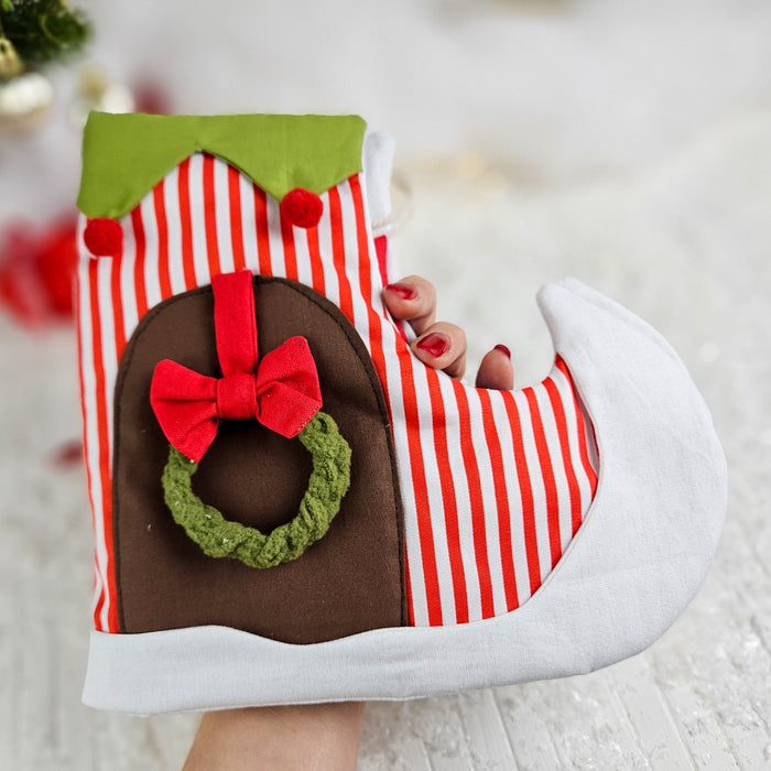 Christmas-themed boot with red and white striped pattern, green top, and decorative elements.