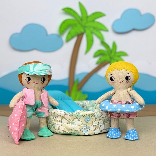 Mini Boy Doll & Pool Day Set beginner-friendly PDF sewing pattern with handmade fabric doll, doll clothes, pool, float, ring, swim fins, shorts, summer vest, and sun visor.
