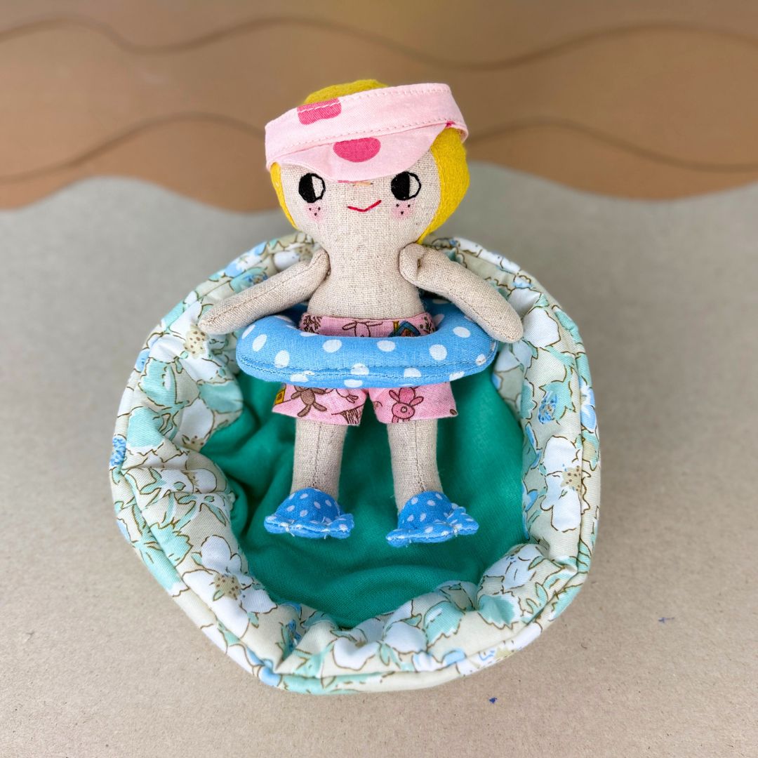 Mini Boy Doll & Pool Day Set beginner-friendly PDF sewing pattern with handmade fabric doll, doll clothes, pool, float, ring, swim fins, shorts, summer vest, and sun visor.
