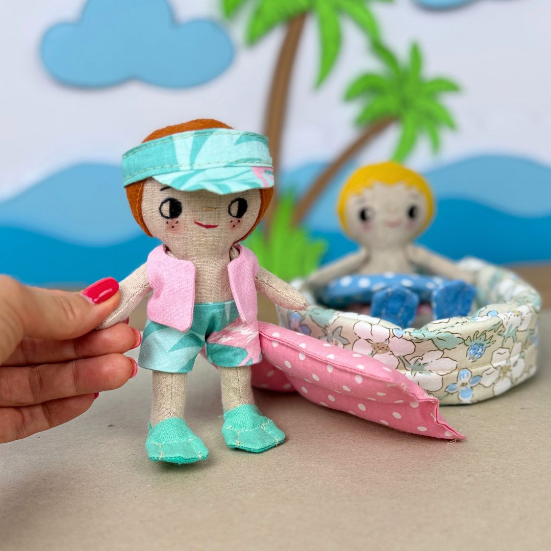 Mini Boy Doll & Pool Day Set beginner-friendly PDF sewing pattern with handmade fabric doll, doll clothes, pool, float, ring, swim fins, shorts, summer vest, and sun visor.