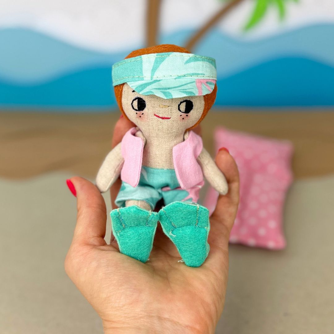 Mini Boy Doll & Pool Day Set beginner-friendly PDF sewing pattern with handmade fabric doll, doll clothes, pool, float, ring, swim fins, shorts, summer vest, and sun visor.